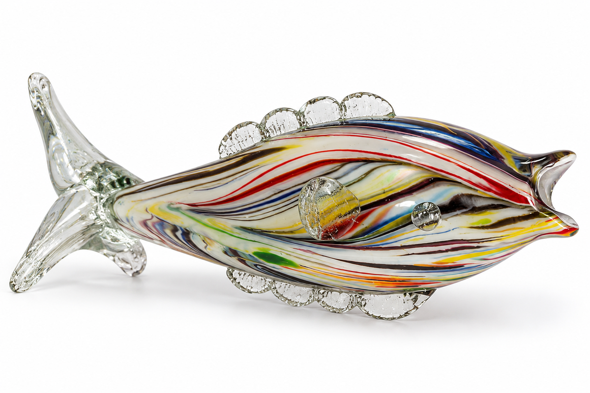 A hand-blown glass fish figurine with vibrant multicolored swirls of red, yellow, blue, green, black, and white, featuring clear glass fin and tail details, set against a plain white background.