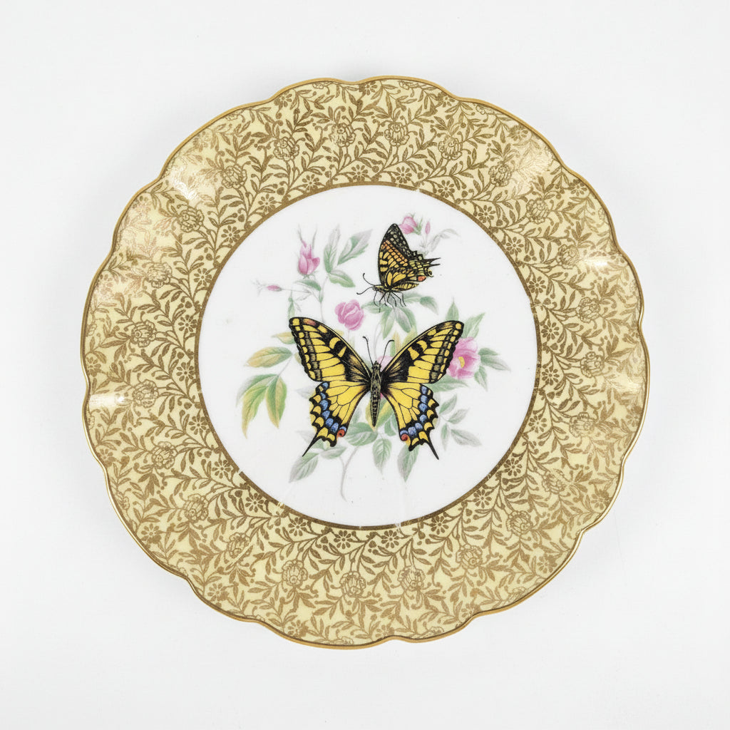 Decorative plate with butterfly design on a gold-rimmed plate