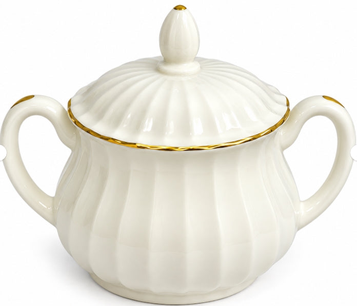 An off-white porcelain sugar bowl with a matching lid, featuring vertical fluted detailing, two side handles, and delicate gold trim accents.