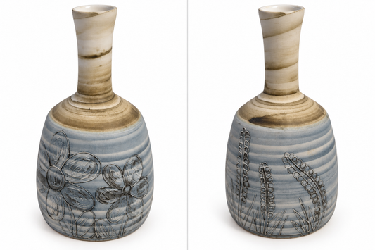 Two views of a ceramic vase with a flared cream and brown neck, a ribbed blue-gray body, and dark engraved floral and grass-like patterns, shown on a white background.