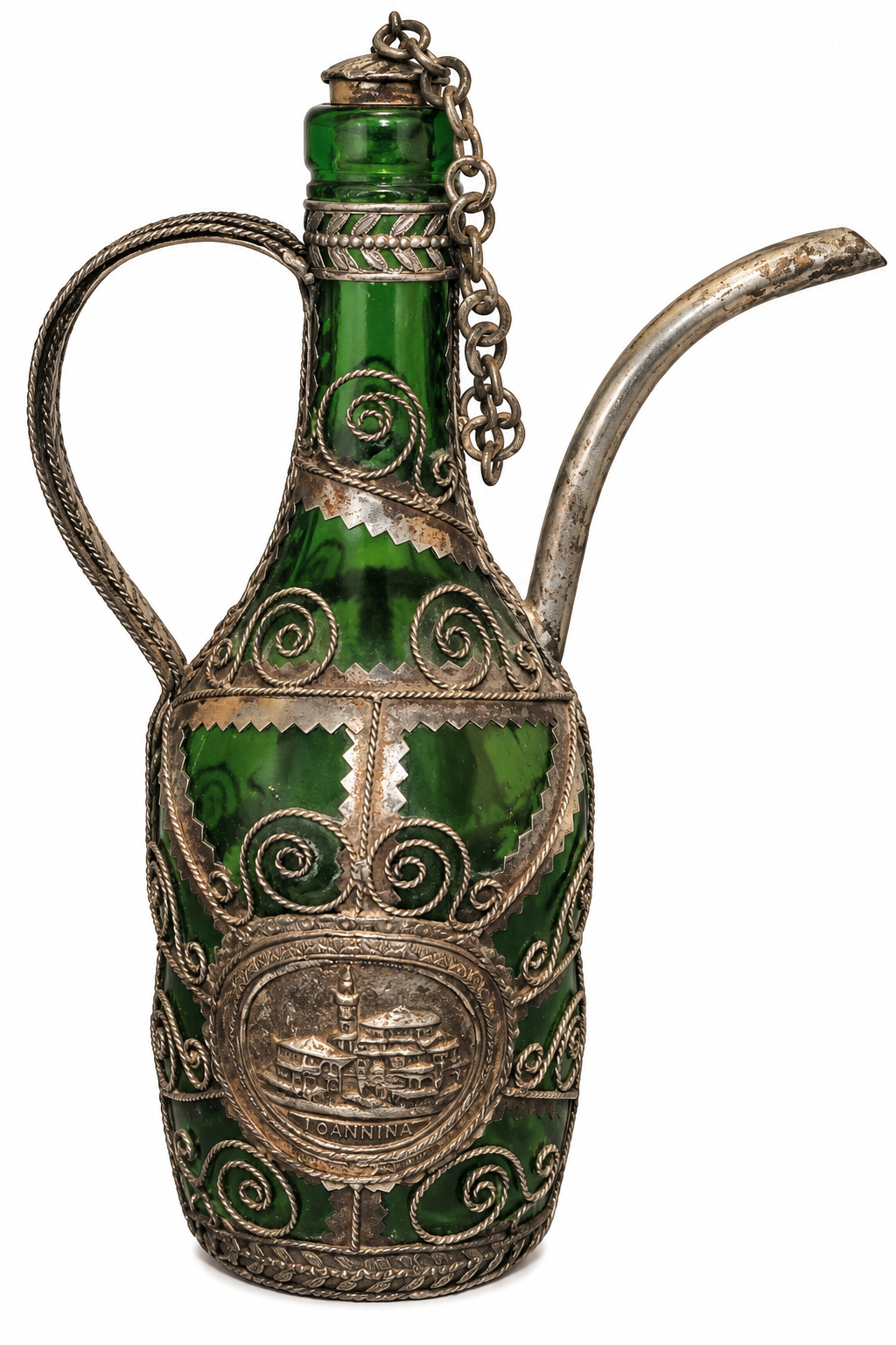A decorative green glass bottle with ornate silver filigree, a chain detail, a loop handle, and a curved spout, shown on a plain white background.